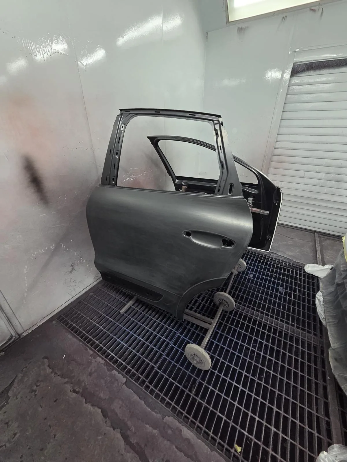 Door panels on stands during the preparation stage.