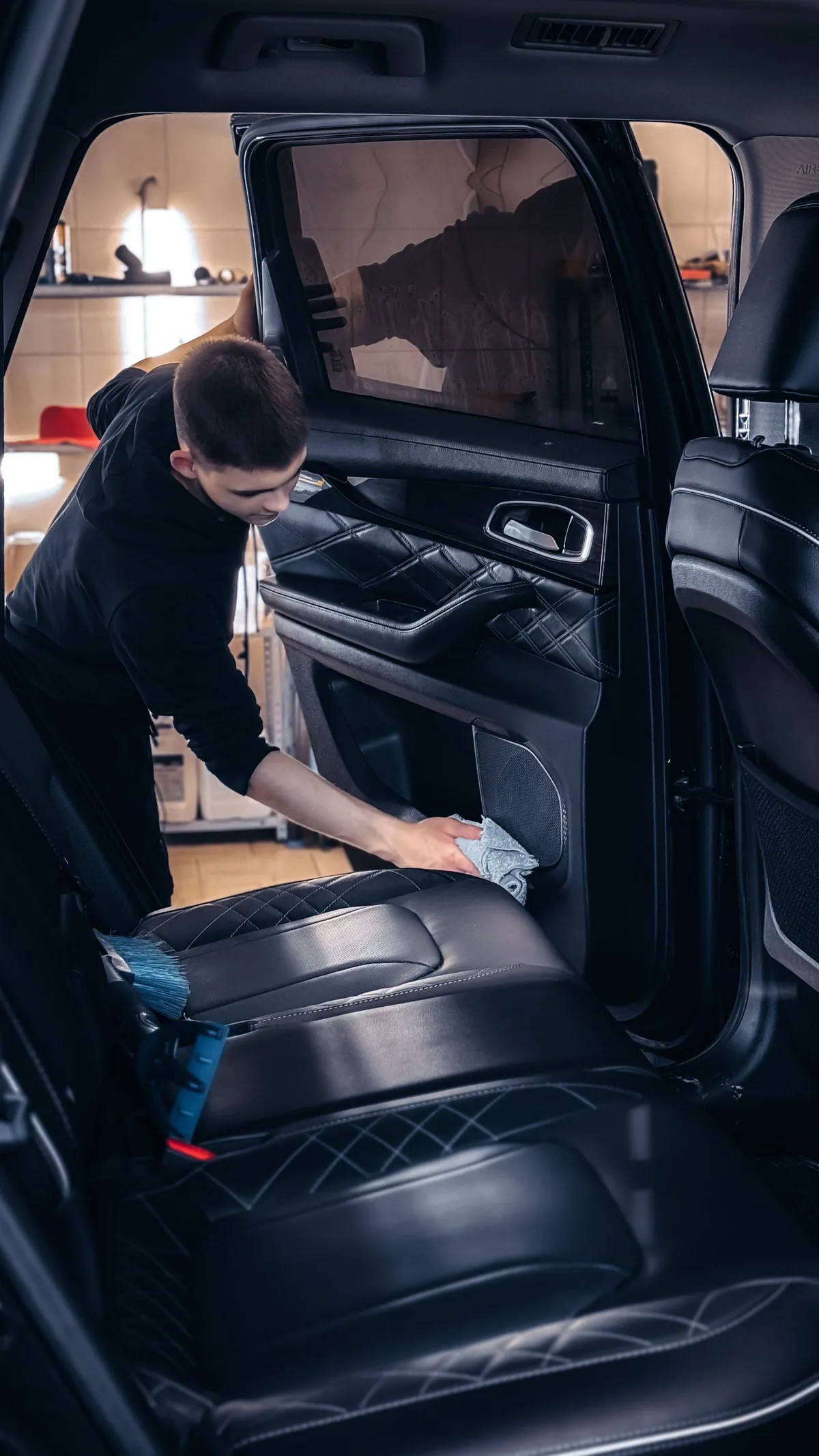 Stock photograph of vehicle interior surfaces being cleaned with a cloth