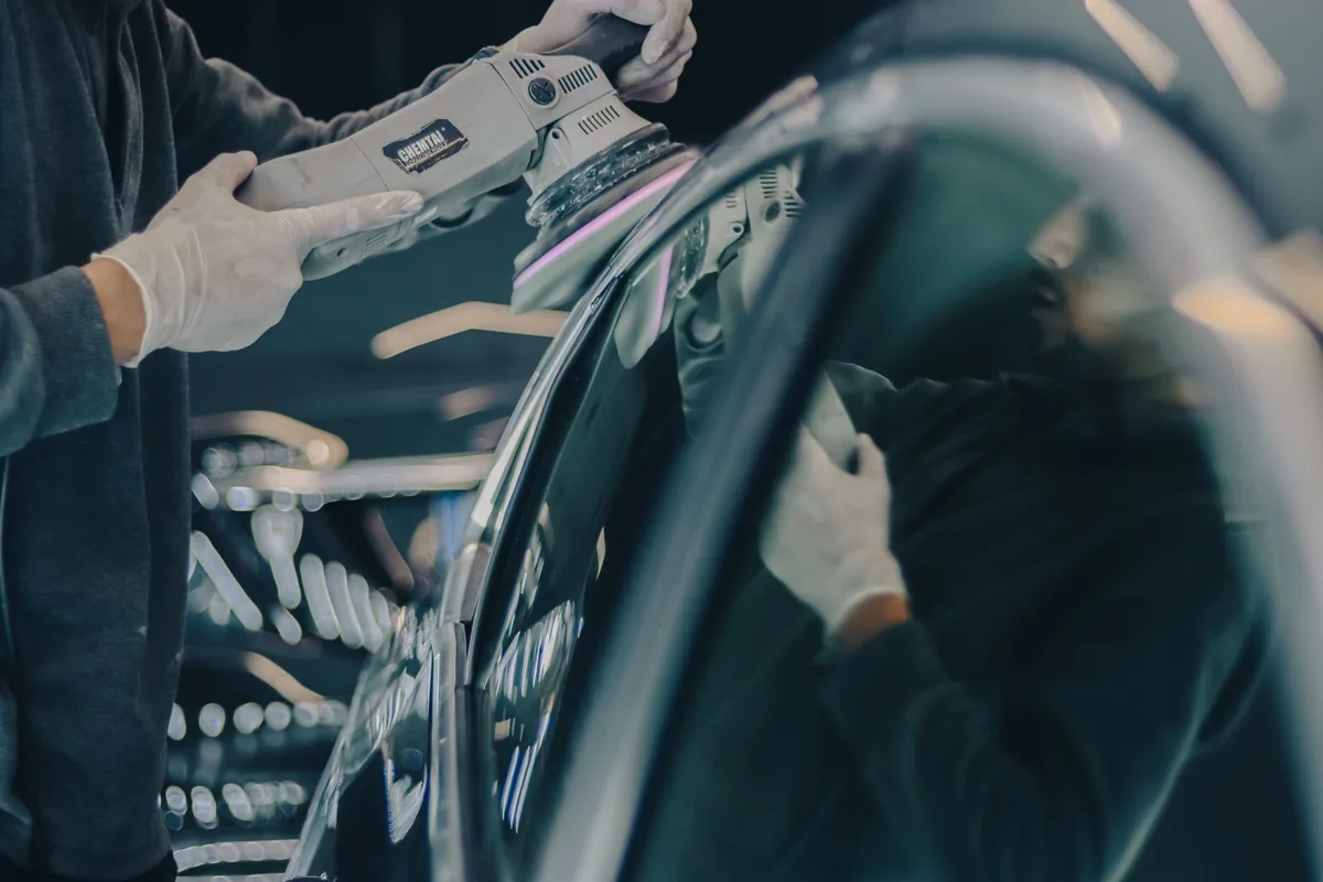 Stock photograph of a person machine polishing a vehicle surface